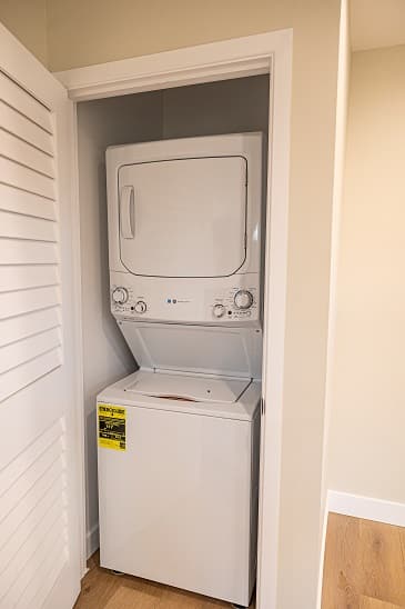 In-unit stacked washer and dryer tucked into a finished ADU closet