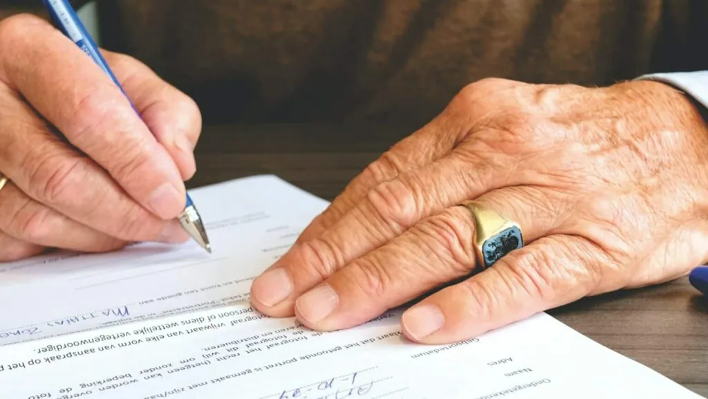 Homeowner signing ADU permit paperwork