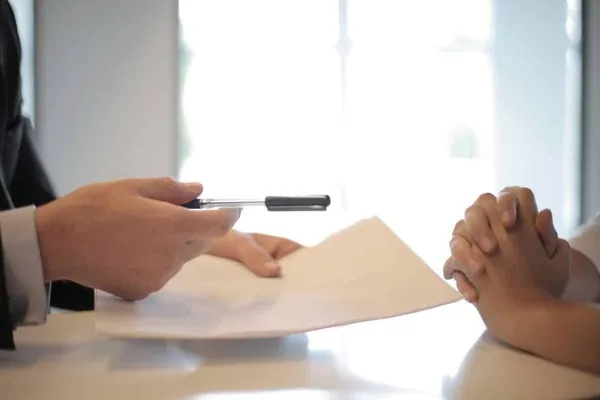 Contractor and homeowner reviewing and signing an ADU conversion agreement