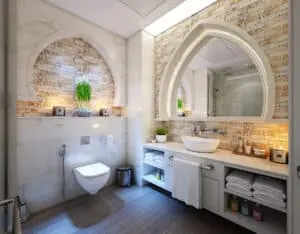 Bathroom with an arched mirror and exposed-brick wall