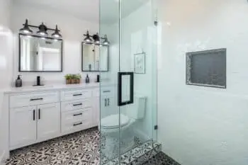 Bathroom with a glass shower and patterned-tile floor
