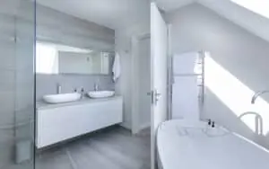 Bright, minimal white bathroom with a freestanding tub