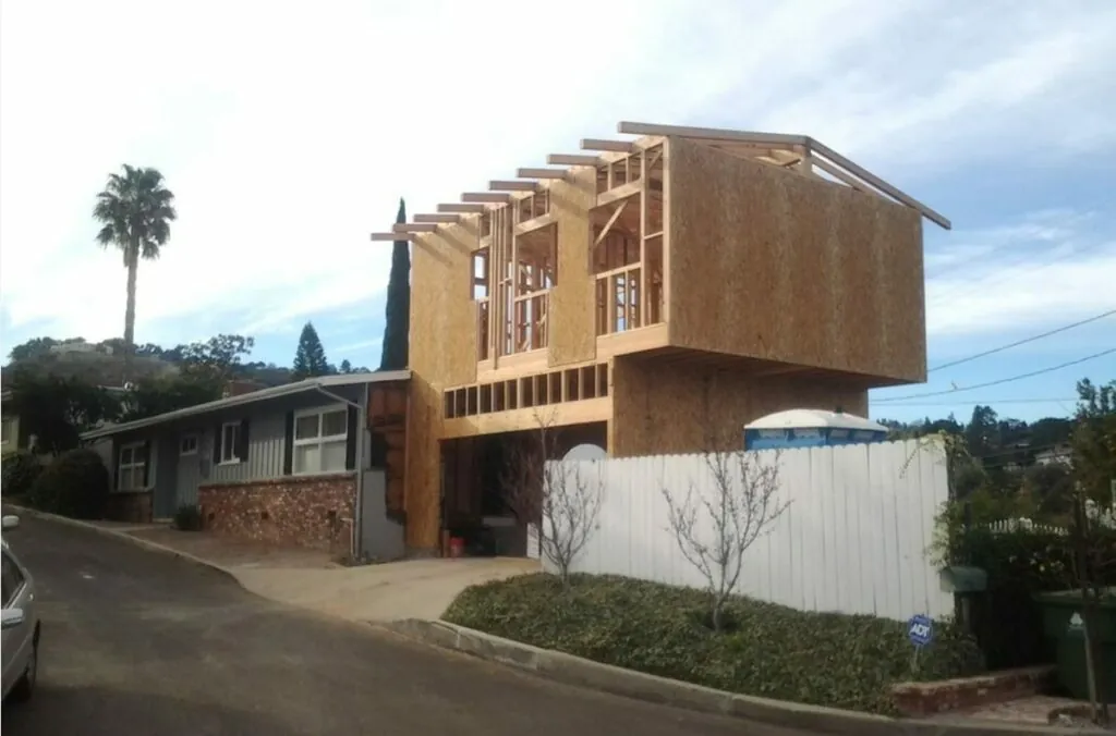 Two-story garage conversion and addition under construction with new framing