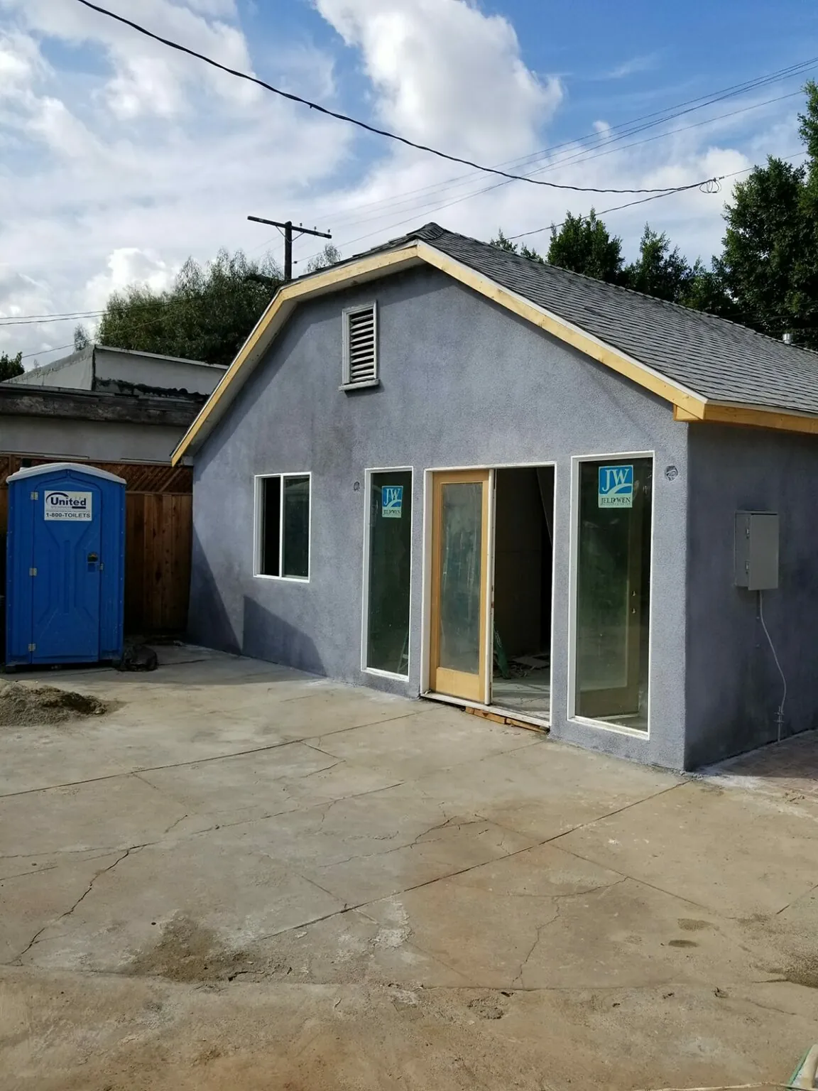 Garage-to-ADU conversion in progress with a new roofline and stucco exterior