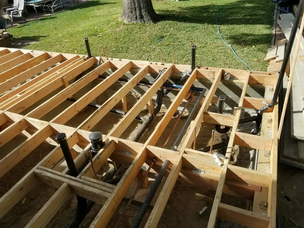 Garage conversion sub-floor framing with new plumbing and electrical rough-ins