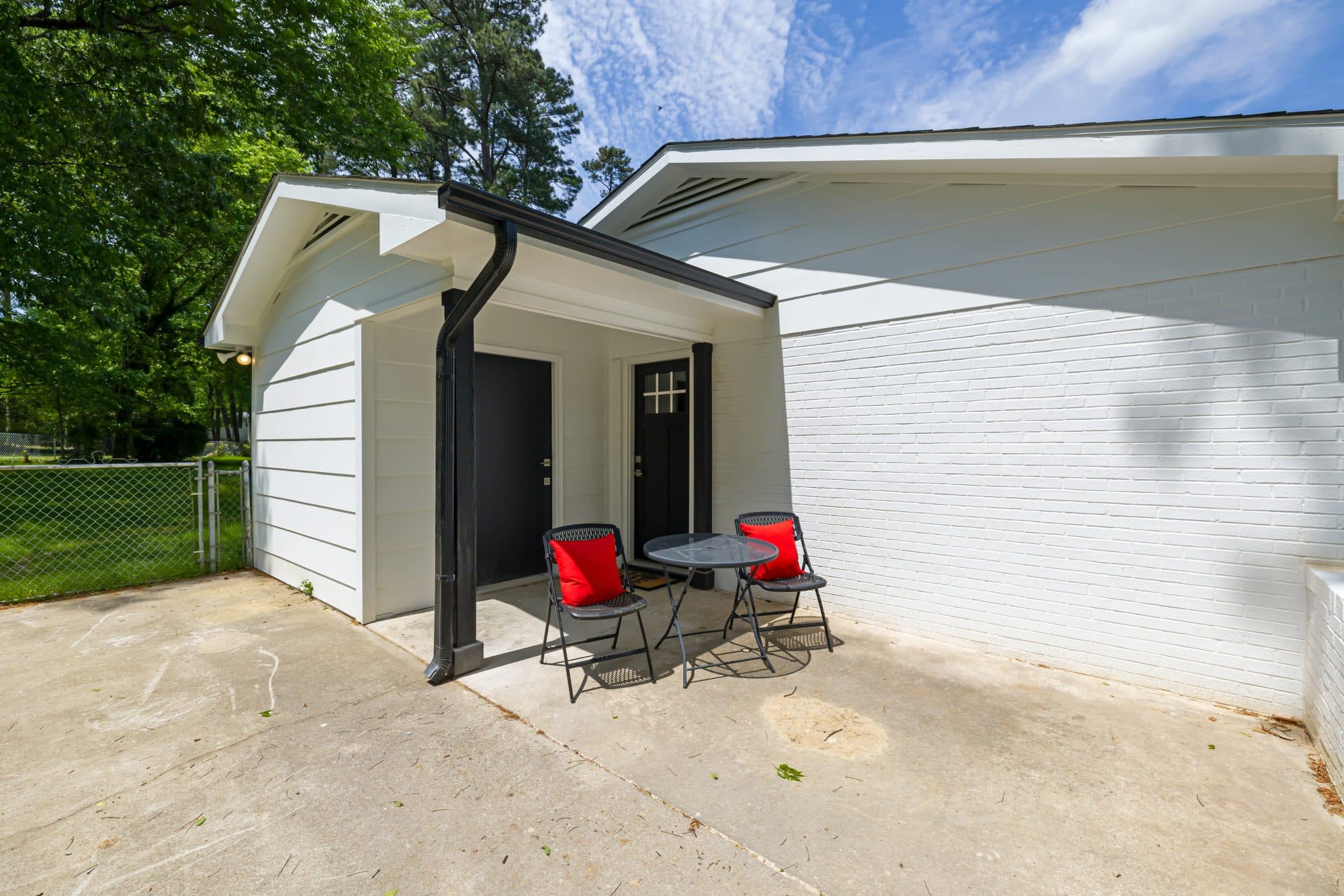 Completed garage conversion exterior with a private patio seating area